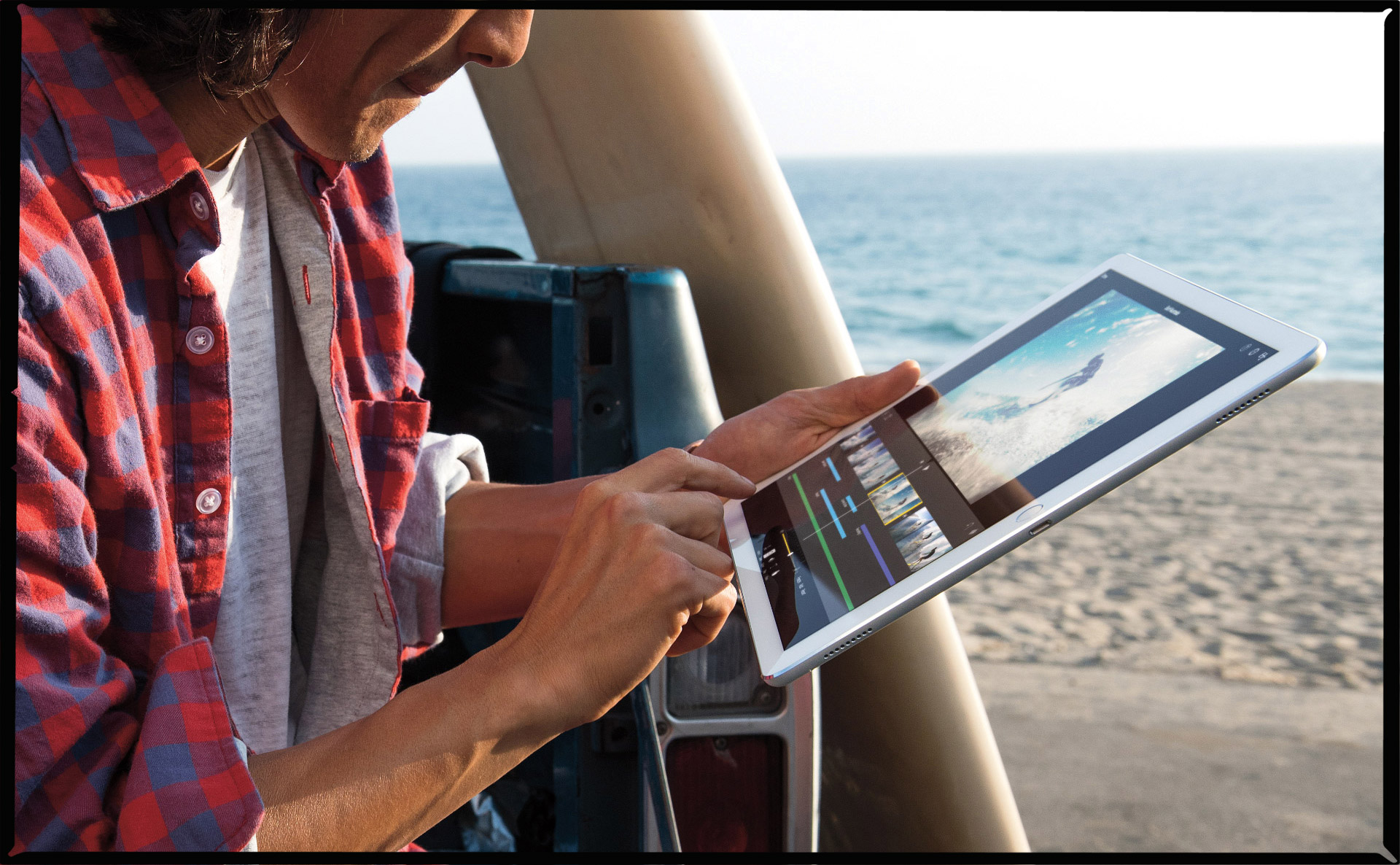 Man uses iPod Pro on the beach.